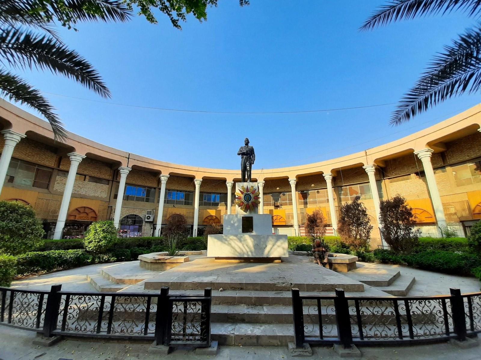 Indian Prime Ministers and Their contribution to India 10 Elegant colonnaded courtyard featuring a prominent statue under a clear blue sky in Baghdad.